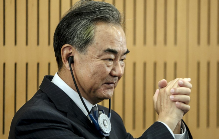Chinese Foreign Minister Wang Yi greets the audience prior a press conference at the Institute for International Relations in Paris, Sunday, Aug. 30, 2020.
