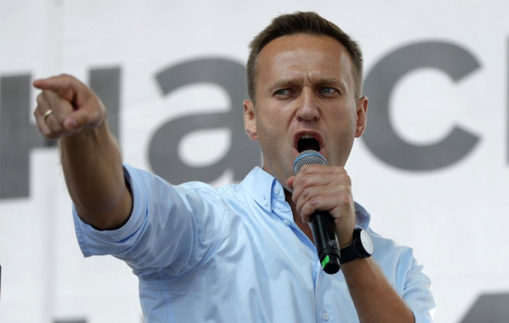 In this Saturday, July 20, 2019 file photo Russian opposition activist Alexei Navalny gestures while speaking to a crowd during a political protest in Moscow, Russia.