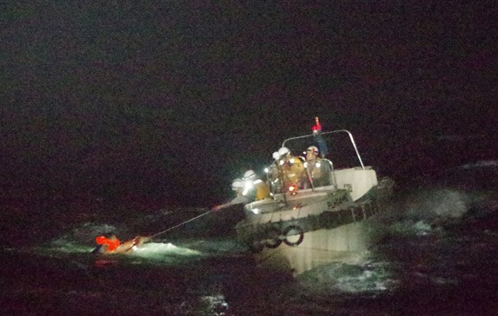 In this photo released by the 10th Regional Japan Coast Guard Headquarters, a Filipino crewmember of a Panamanian cargo ship is rescued by Japanese Coast Guard members in the waters off the A