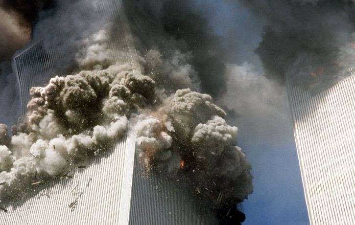 In this Sept. 11, 2001, file photo, the south tower of the World Trade Center, left, begins to collapse after a terrorist attack on the landmark buildings in New York.