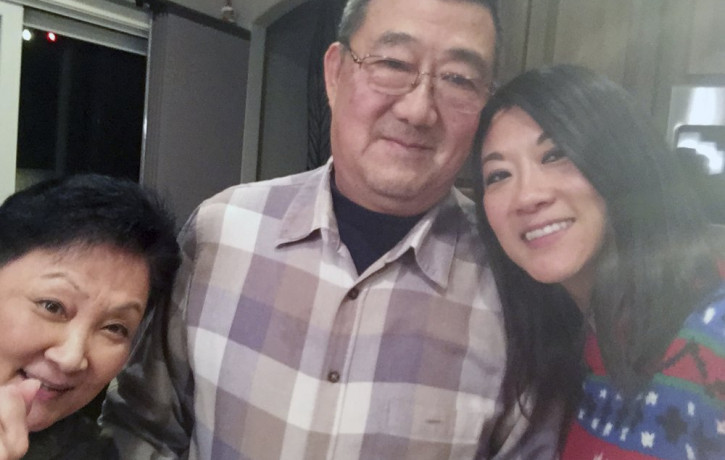 This December 2016 photo provided by the family shows, from left, Lu Wang, Ming Wang and Anne Peterson. Ming Wang, 71, was sickened in March 2020 on a cruise from Australia with his wife.