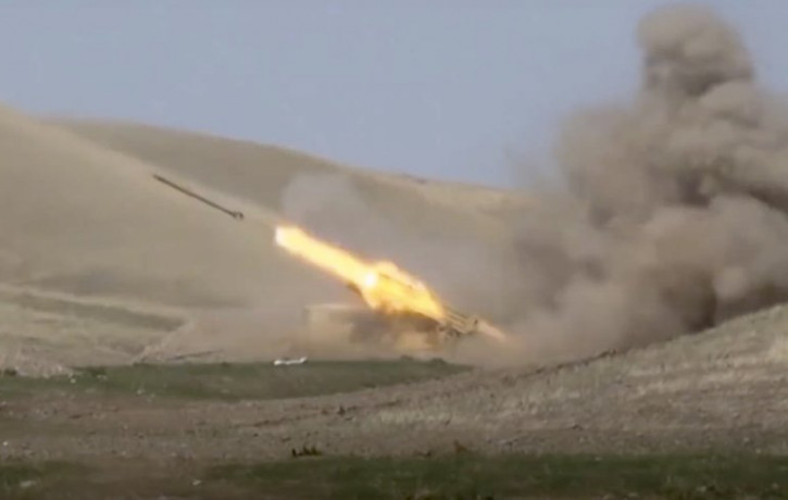 In this image taken from footage released by Azerbaijan's Defense Ministry on Sunday, Sept. 27, 2020, an Azerbaijan's rocket launches from missile system at the contact line of the self-procl