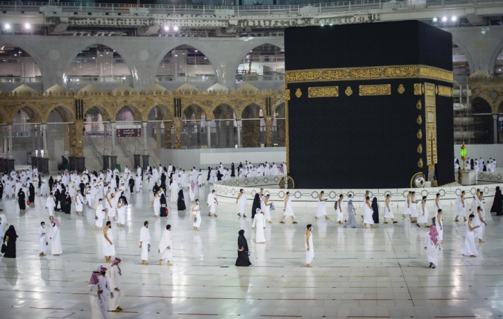 In this photo released by Saudi Ministry of Hajj and Umrah, Muslims pray around the Kaaba, the cubic building at the Grand Mosque, during the first day of Umrah in the Muslim holy city of Mec