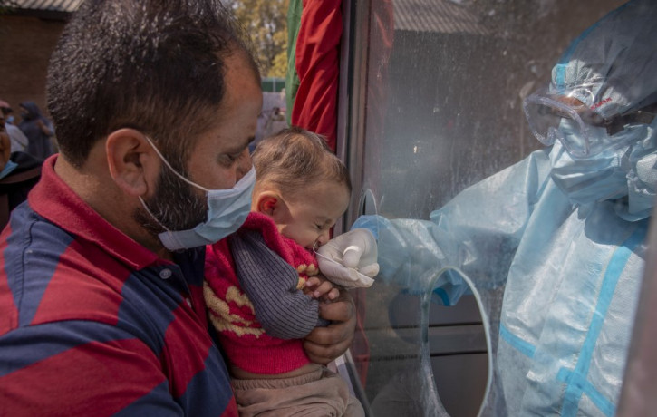 A Kashmiri health worker takes a nasal swab sample of a child to test for COVID-19 in Srinagar, Indian-controlled Kashmir, Tuesday, Oct. 6, 2020. India is the second worst-nation in terms of 