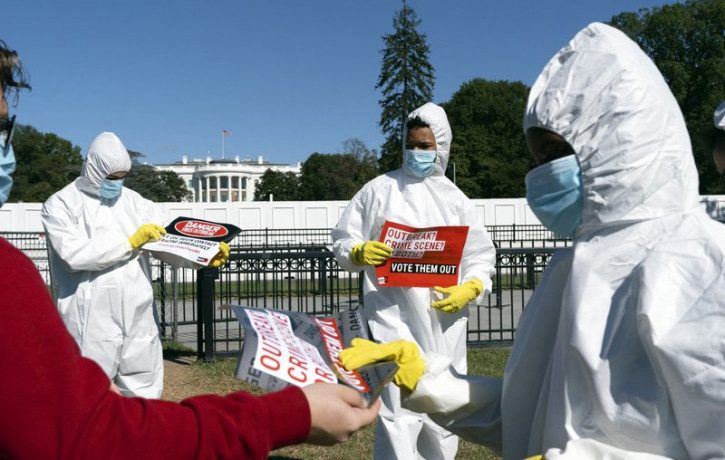 A group protests the ongoing outbreak of coronavirus in the White House, Thursday, Oct. 8, 2020, outside the White House in Washington.