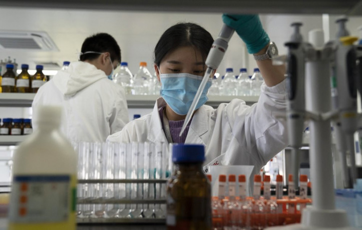 In this Sept. 24, 2020, file photo, an employee of SinoVac works in a lab at a factory producing its SARS-CoV-2 vaccine for COVID-19 named CoronaVac in Beijing.