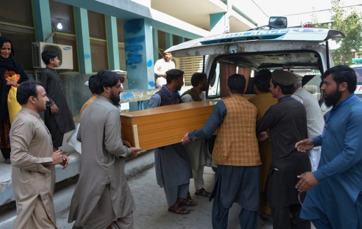 Relatives carry the coffin of a victim killed in the stampede, outside a mortuary in Jalalabad.