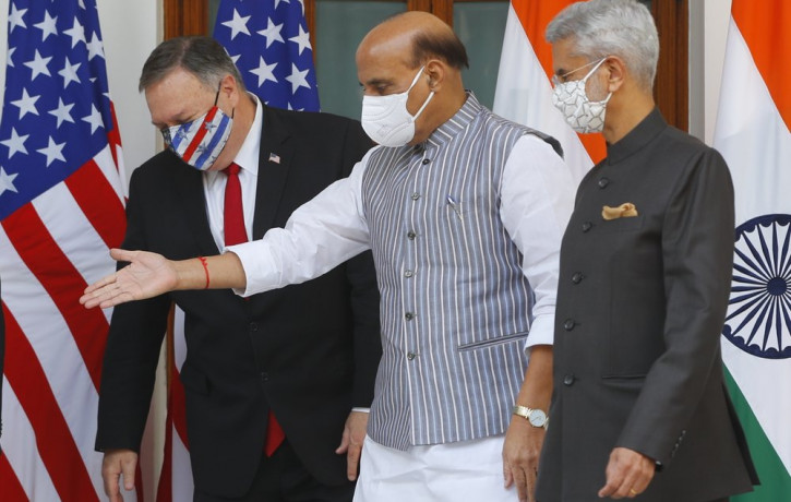 Indian Defence Minister Rajnath Singh, center, gestures towards U.S. Secretary of State Mike Pompeo, left, with Indian Foreign Minister Subrahmanyam Jaishankar, right, standing beside him, ah