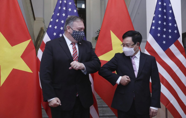 U.S. Secretary of State Mike Pompeo, left, and Vietnamese Foreign Minister Pham Binh Minh gesture with their elbows before a meeting in Hanoi, Vietnam, Friday, Oct. 30, 2020.