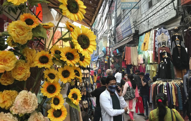 People shop ahead of Diwali, the Hindu festival of lights, at the Lajpat Nagar market in New Delhi, India, Monday, Nov. 9, 2020.