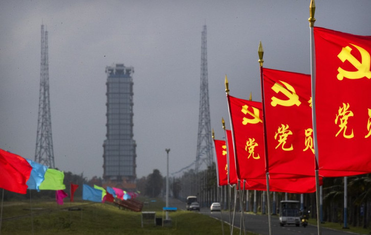 Flags with the logo of the Communist Party of China fly in the breeze near a launch pad at the Wenchang Space Launch Site in Wenchang in southern China's Hainan province, Monday, Nov. 23, 202