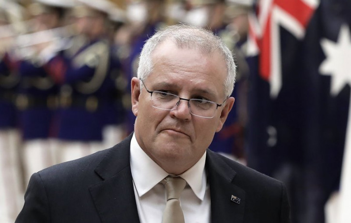 In this Nov. 17, 2020, file photo, Australian Prime Minister Scott Morrison reviews an honor guard during a ceremony ahead of a meeting at Japanese Prime Minister Yoshihide Suga's official re