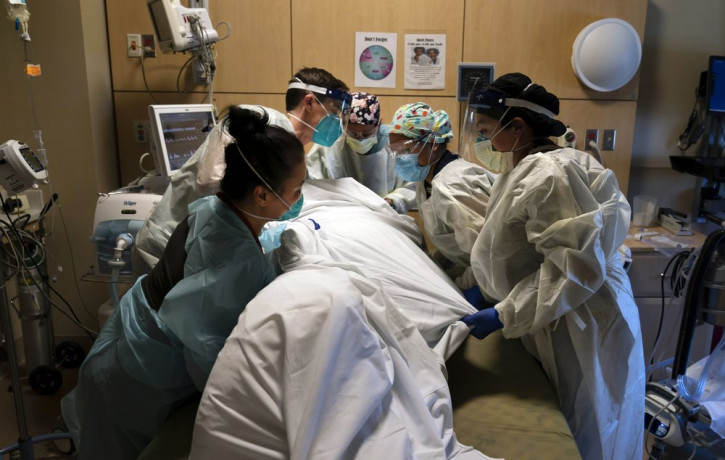 In this Nov. 19, 2020, file photo, medical personnel prone a COVID-19 patient at Providence Holy Cross Medical Center in the Mission Hills section of Los Angeles.