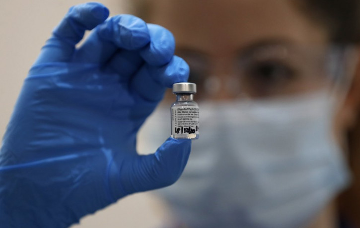 A nurse holds a phial of the Pfizer-BioNTech COVID-19 vaccine at Guy's Hospital in London, Tuesday, Dec. 8, 2020, as the U.K. health authorities rolled out a national mass vaccination program