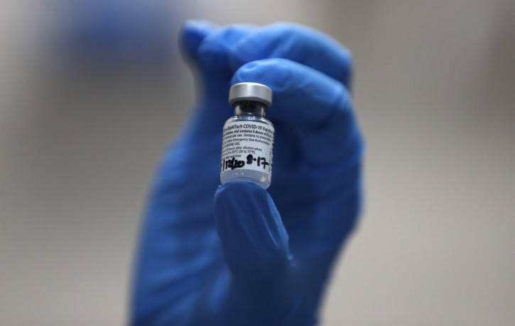 In this Tuesday, Dec. 8, 2020 file photo, a nurse holds a phial of the Pfizer-BioNTech COVID-19 vaccine at Guy's Hospital in London.