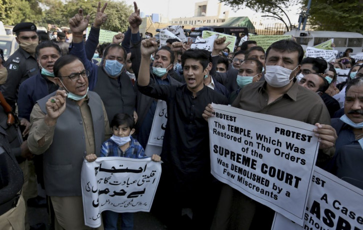 Members of Pakistan Hindu Council hold a protest against the attack on a Hindu temple in the northwestern town of Karak, in Karachi, Pakistan, Thursday, Dec. 31, 2020.