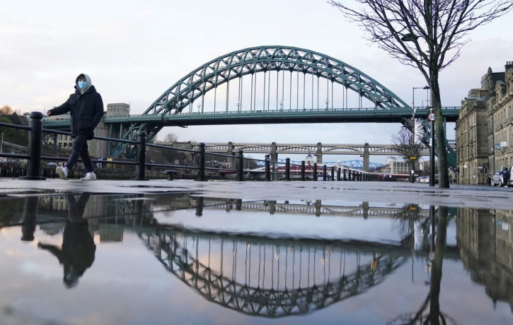 Nearly empty pavements on the normally busy Quayside in Newcastle upon Tyne, northern England, early Tuesday Jan. 5, 2021, the morning after new stay home coronavirus restrictions were impose