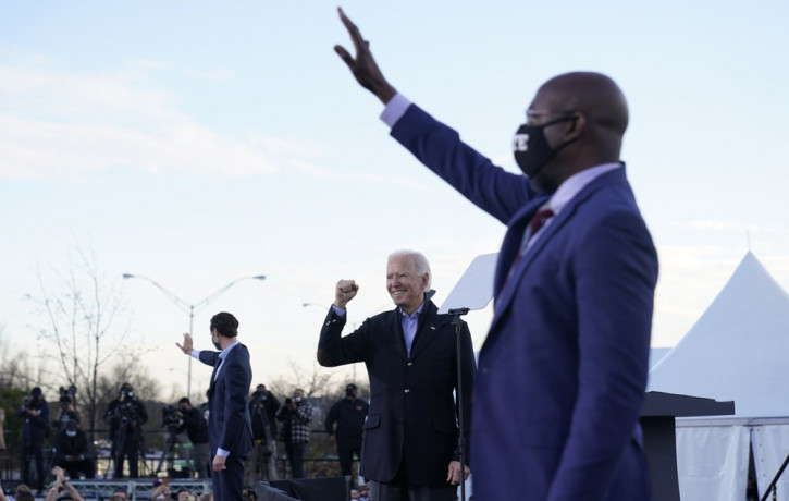 US President-elect Joe Biden campaigns in Atlanta, Monday, Jan. 4, 2021, for Senate candidates Raphael Warnock, right, and Jon Ossoff, left.