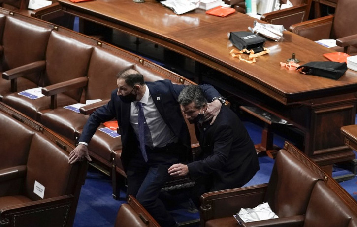 Lawmakers evacuate the floor as protesters try to break into the House Chamber at the U.S. Capitol on Wednesday, Jan. 6, 2021, in Washington.