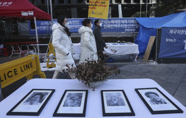 Portraits of late former South Korean comfort women are displayed near the Japanese Embassy in Seoul, South Korea, Friday, Jan. 8, 2021.
