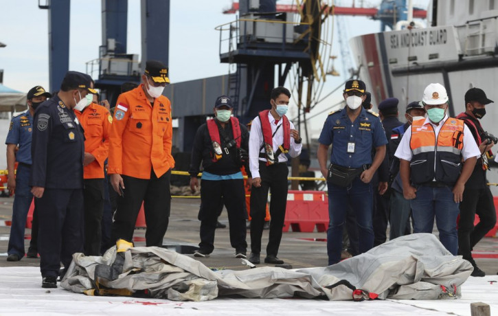 Rescuers inspect debris found in the waters around the location where a Sriwijaya Air passenger jet has lost contact with air traffic controllers shortly after the takeoff, at the search and 