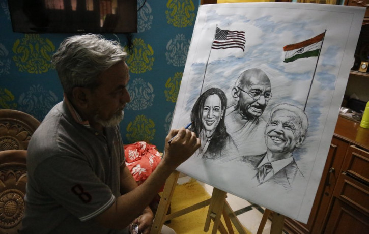 An Indian artist Aejaz Saiyed gives finishing touch to an art work featuring U.S.President-elect Joe Biden, Vice President-elect Kamala Harris and Indian freedom fighter Mahatma Gandhi, ahead