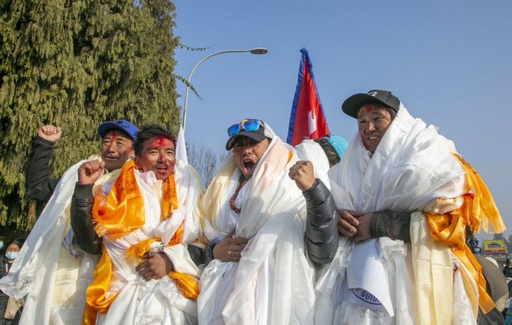 The all-Nepalese mountaineering team that became the first to scale Mount K2 in winter cheer as they arrive at Tribhuwan International airport in Kathmandu, Nepal, Tuesday, Jan. 26, 2021.