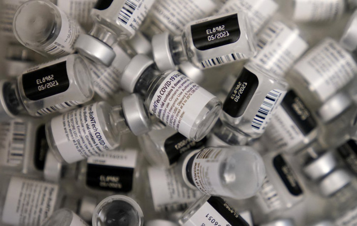 In this Friday, Jan. 22, 2021 file photo, empty vials of the Pfizer-BioNTech COVID-19 vaccine are seen at a vaccination center at the University of Nevada, Las Vegas in Las Vegas.