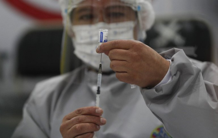 A healthcare worker prepares a dose of Russia's Sputnik V COVID-19 vaccine, at the Del Norte Hospital in El Alto, Bolivia, Saturday, Jan. 30, 2021.