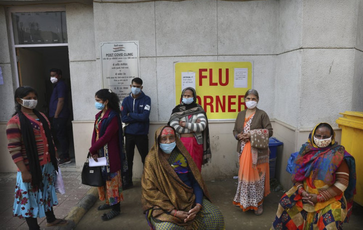 People wait outside a health center to get tested for COVID-19 in New Delhi, India, Thursday, Feb. 11, 2021.