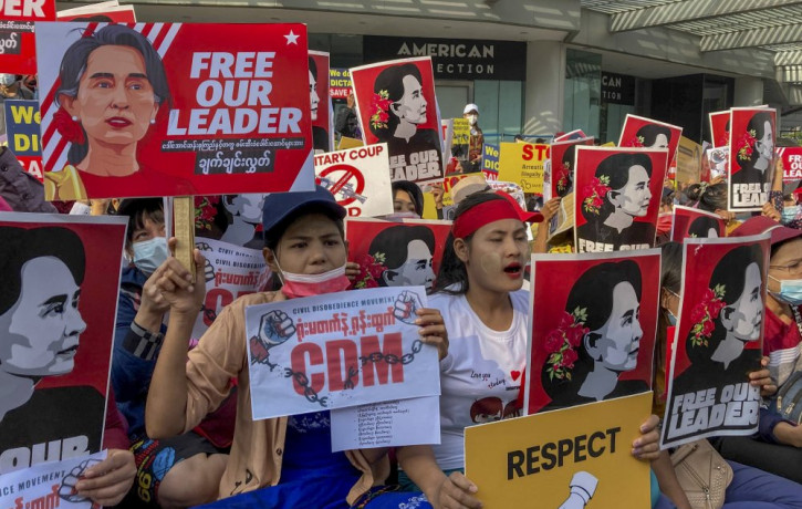 Demonstrators display images of detained Myanmar leader Aung San Suu Kyi during a protest against the military coup in Yangon, Myanmar, Tuesday, Feb. 16, 2021.