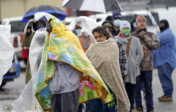 People wait in line to fill propane tanks Wednesday, Feb. 17, 2021, in Houston. Customers waited over an hour in the freezing rain to fill their tanks.
