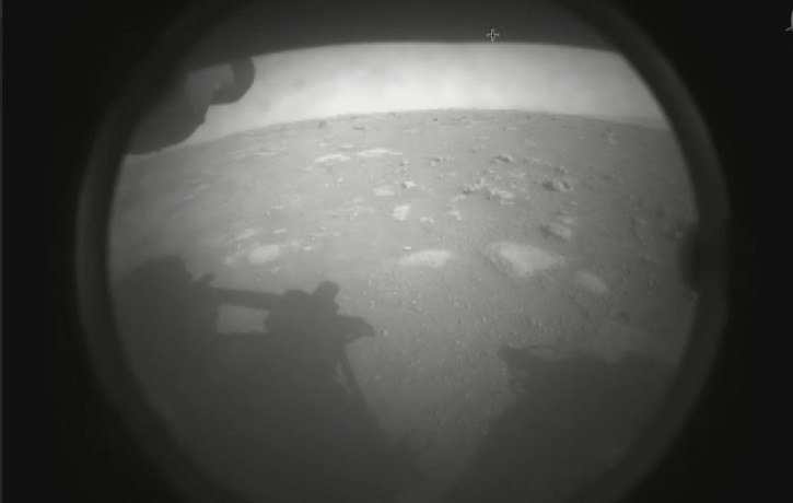 This photo made available by NASA shows the first image sent by the Perseverance rover showing the surface of Mars, just after landing in the Jezero crater, on Thursday, Feb. 18, 2021.
