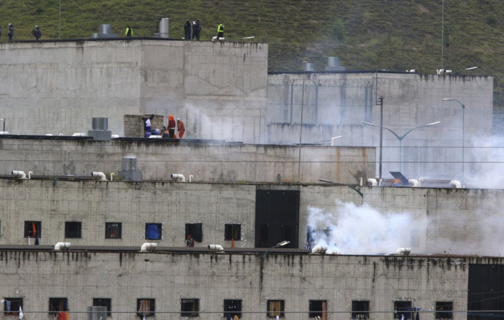 Tear gas rises from parts of Turi jail where an inmate riot broke out in Cuenca, Ecuador, Tuesday, Feb. 23, 2021.