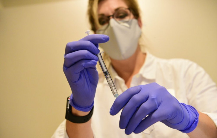 This September 2020, file photo provided by Johnson & Johnson shows a pharmacist preparing to give an experimental COVID-19 vaccine.