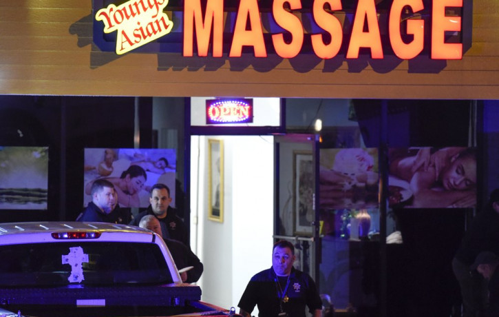 Authorities investigate a fatal shooting at a massage parlor, late Tuesday, March 16, 2021, in Acworth, Georgia.