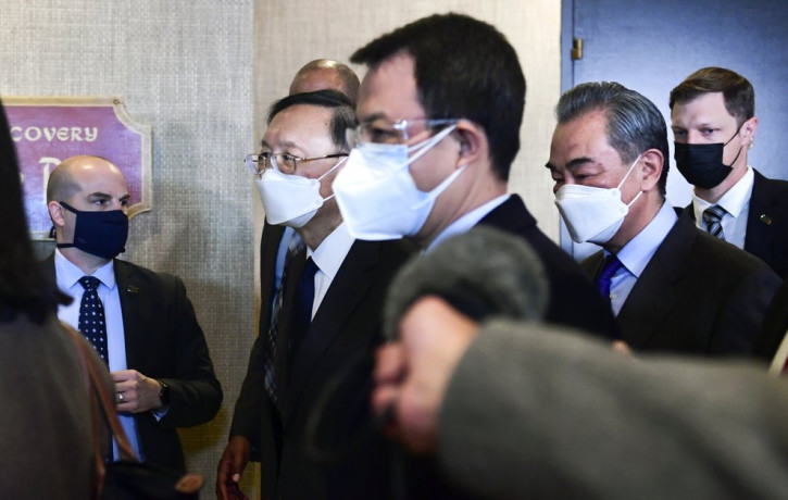 Chinese Communist Party foreign affairs chief Yang Jiechi, second from left, and China's State Councilor Wang Yi, second from right, depart the ballroom from the closed-door morning session o