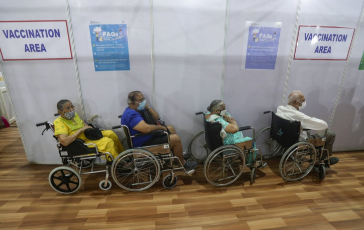 Elderly Indians on wheel chairs wait in a queue to receive COVID-19 vaccine in Mumbai, India, Monday, March 8, 2021.