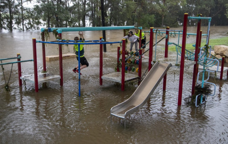People play on equipment at a playground on the banks of the Nepean River at Jamisontown on the western outskirts of Sydney Monday, March 22, 2021.
