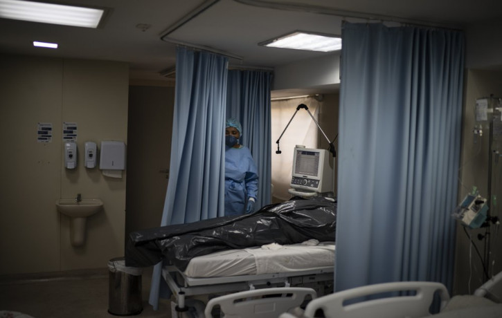 The body of a COVID-19 victim lies in a body bag at the ICU of the Sao Jose municipal hospital in Duque de Caxias, Brazil, Wednesday, March 24, 2021.