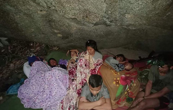 In this photo provided by Free Burma Rangers, villagers shelter in the open due to airstrikes, Saturday, March 27, 2021, in Deh Bu Noh, in Karen state, Myanmar.