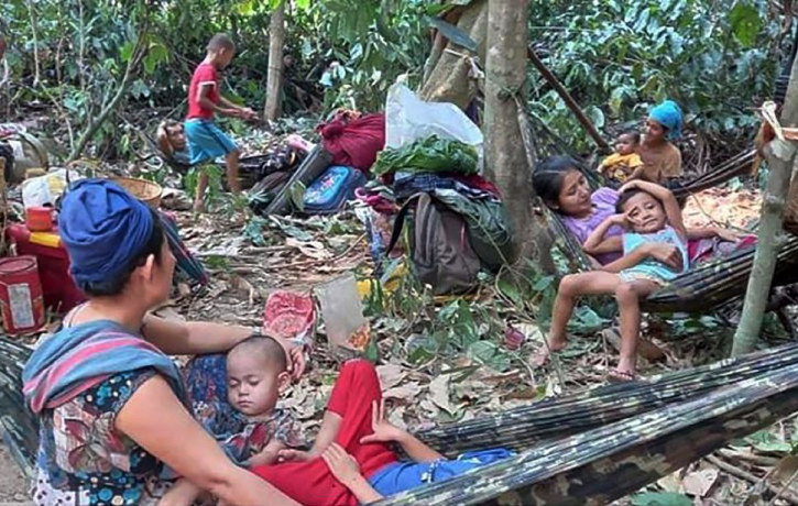 In this photo released by the Free Burma Rangers, Karen villagers gather in the forests as they hide from military airstrikes in the Deh Bu Noh area of the Papun district, north Karen state, 