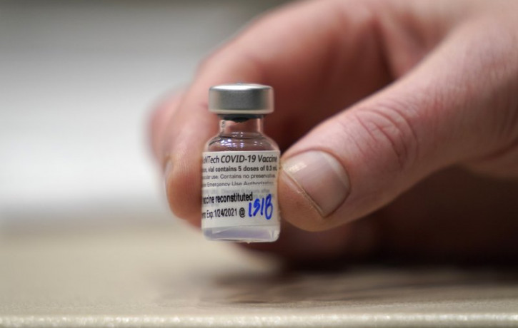 In this Jan. 24, 2021, file photo, a vial of the Pfizer vaccine for COVID-19 is shown at a one-day vaccination clinic set up in an Amazon.com facility in Seattle and operated by Virginia Maso