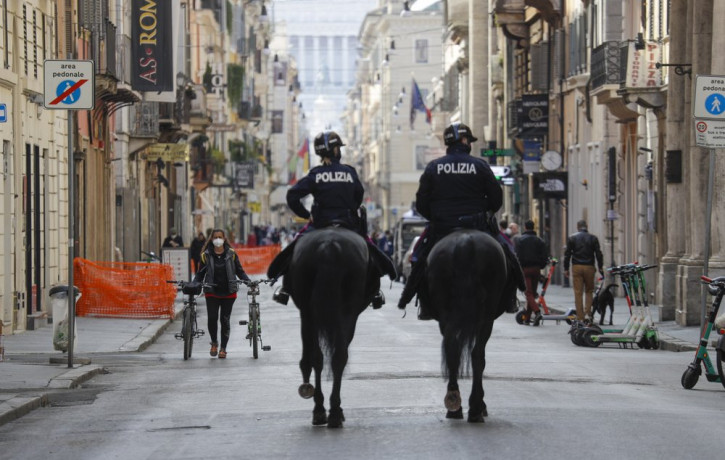 Mounted police officers patrol Via del Corso main shopping street, in downtown Rome, Saturday, April 3, 2021. Italy went into lockdown on Easter weekend in its effort to battle then Covid-19 