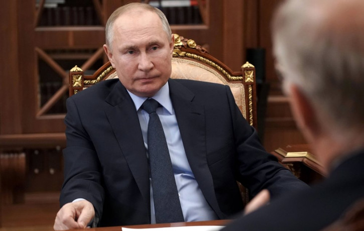 Russian President Vladimir Putin listens to General Director of the Russian Direct Investment Fund Krill Dmitriev at the Kremlin in Moscow, Russia, Friday, April 2, 2021.