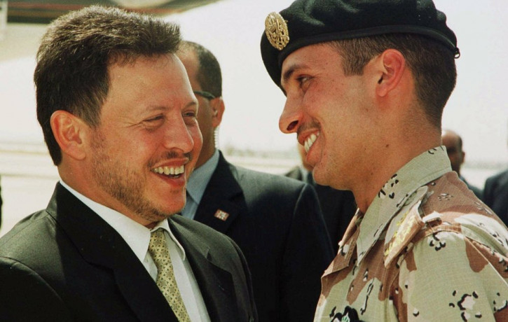 In this April 2, 2001, file photo, Jordan’s King Abdullah II laughs with his half brother Prince Hamzah, right, shortly before the monarch embarked on a tour of the United States.