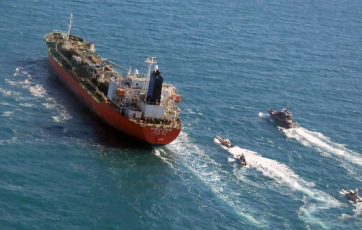 In this Jan. 4, 2021, file photo released by Tasnim News Agency, a seized South Korean-flagged tanker is escorted by Iranian Revolutionary Guard boats on the Persian Gulf.