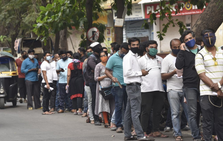 People wait in queues outside the office of the Chemists Association to demand necessary supply of the anti-viral drug Remdesivir, in Pune, India, Thursday, April 8, 2021.