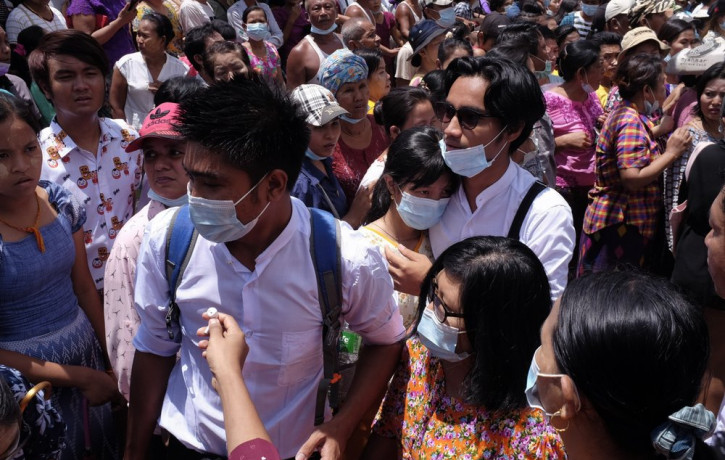 Zay Yar Lwin, center left in white, and Paing Pyo Min,center right in whitewalk through a crowd after their release from Insein prison in Yangon, Myanmar, Saturday, April 17, 2021.