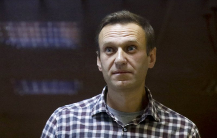 In this Saturday, Feb. 20, 2021 file photo, Russian opposition leader Alexei Navalny stands in a cage in the Babuskinsky District Court in Moscow, Russia.